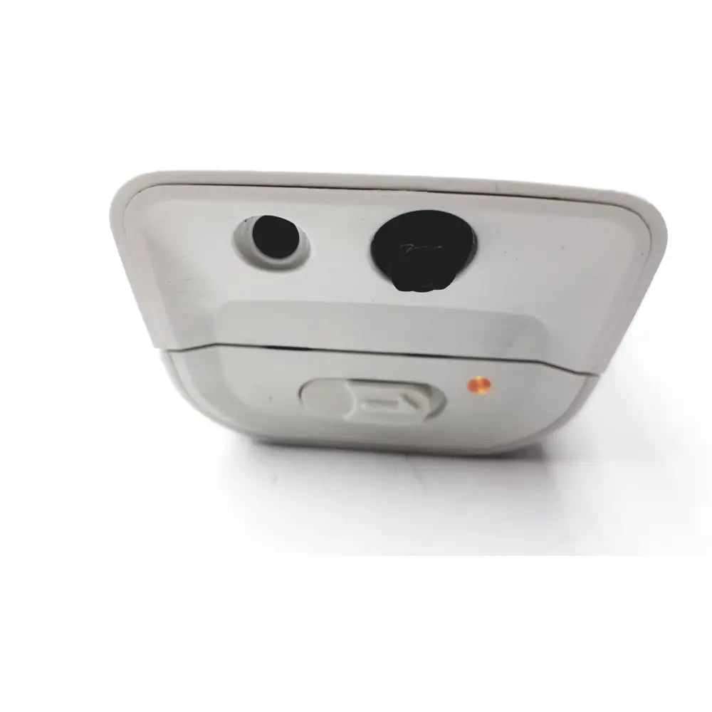 White plastic back side of philips respiironics alice pdx portable sleep diagnostic system with two black ports and orange light