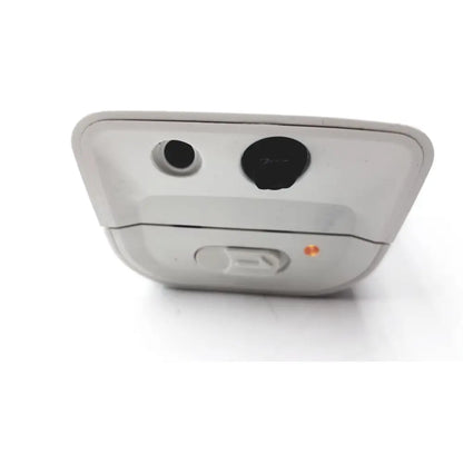 White plastic back side of philips respiironics alice pdx portable sleep diagnostic system with two black ports and orange light