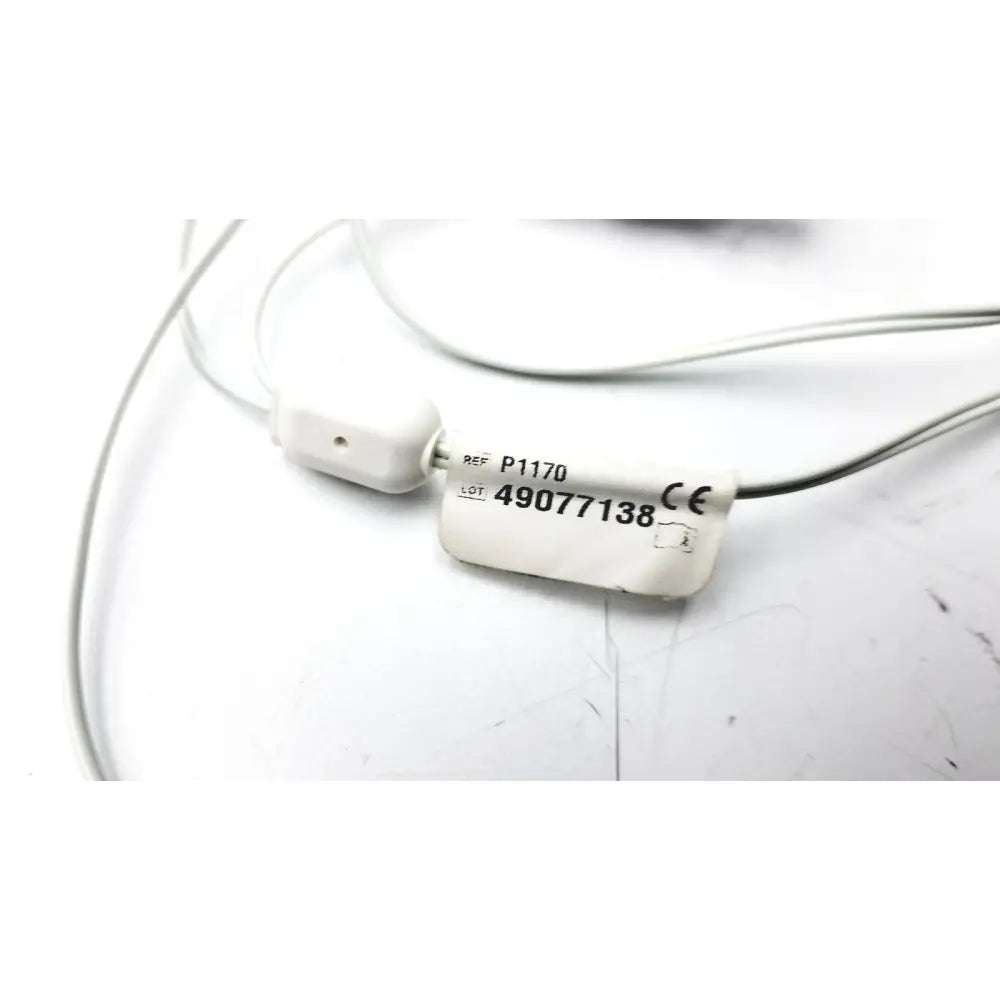 White plastic medical cable connector with printed reference and lot numbers for philips respiironics alice pdx portable device