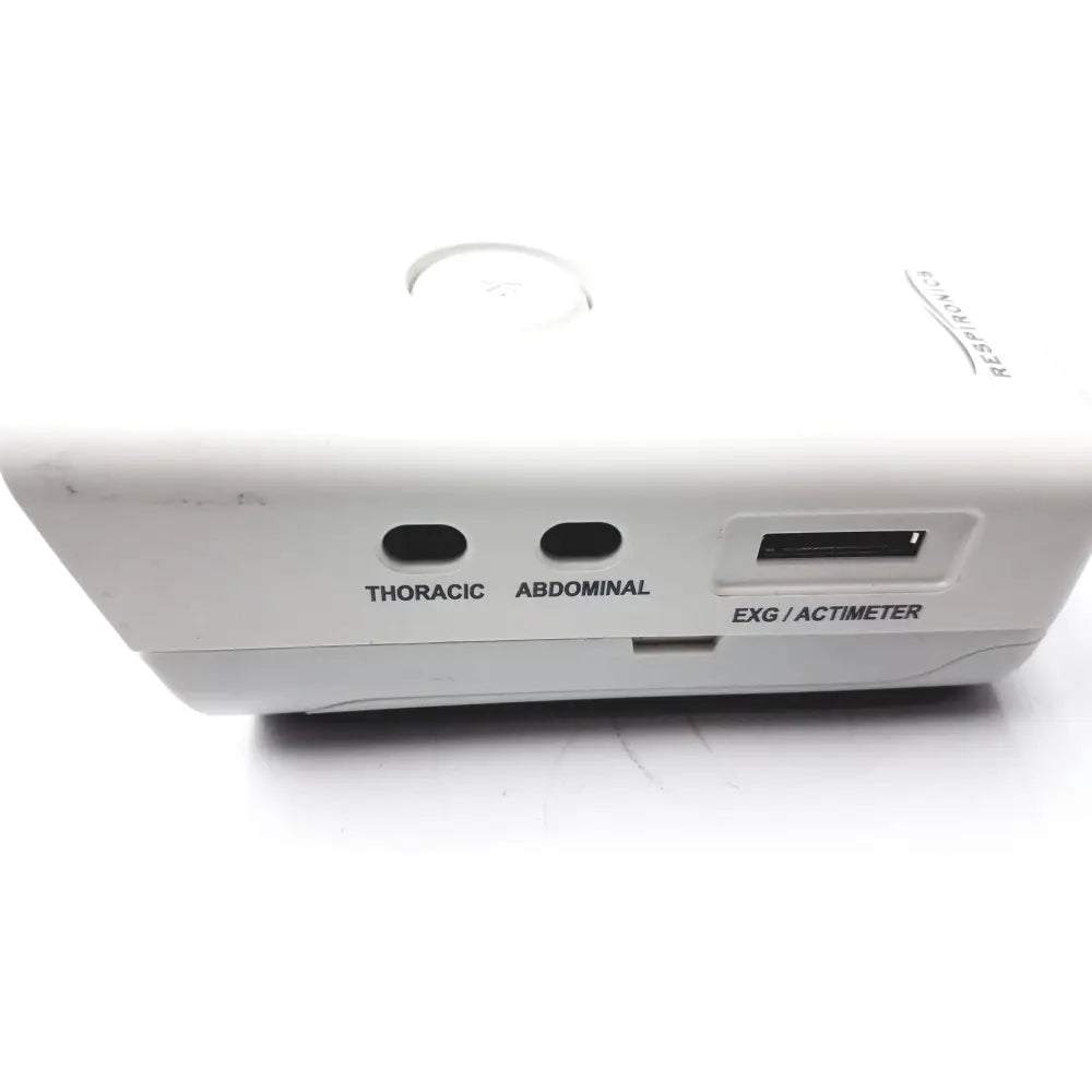 White plastic Philips Respiironics Alice PDx portable sleep diagnostic system with labeled thoracic and abdominal sensors