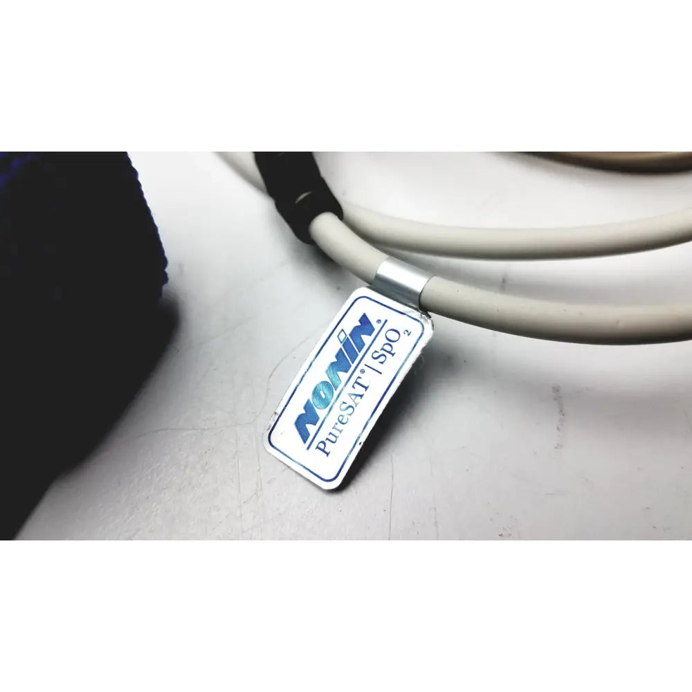 A rectangular silver label with blue and black text nonin puresat spo2 attached to a coiled gray cable for philips respiironics alice pdx portable sleep diagnostic system