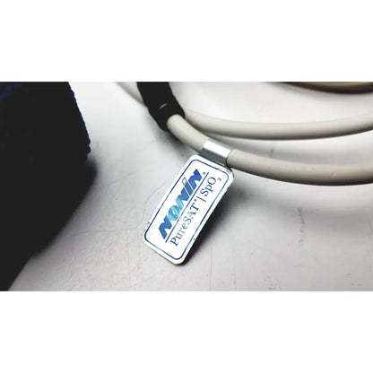 A rectangular silver label with blue and black text nonin puresat spo2 attached to a coiled gray cable for philips respiironics alice pdx portable sleep diagnostic system