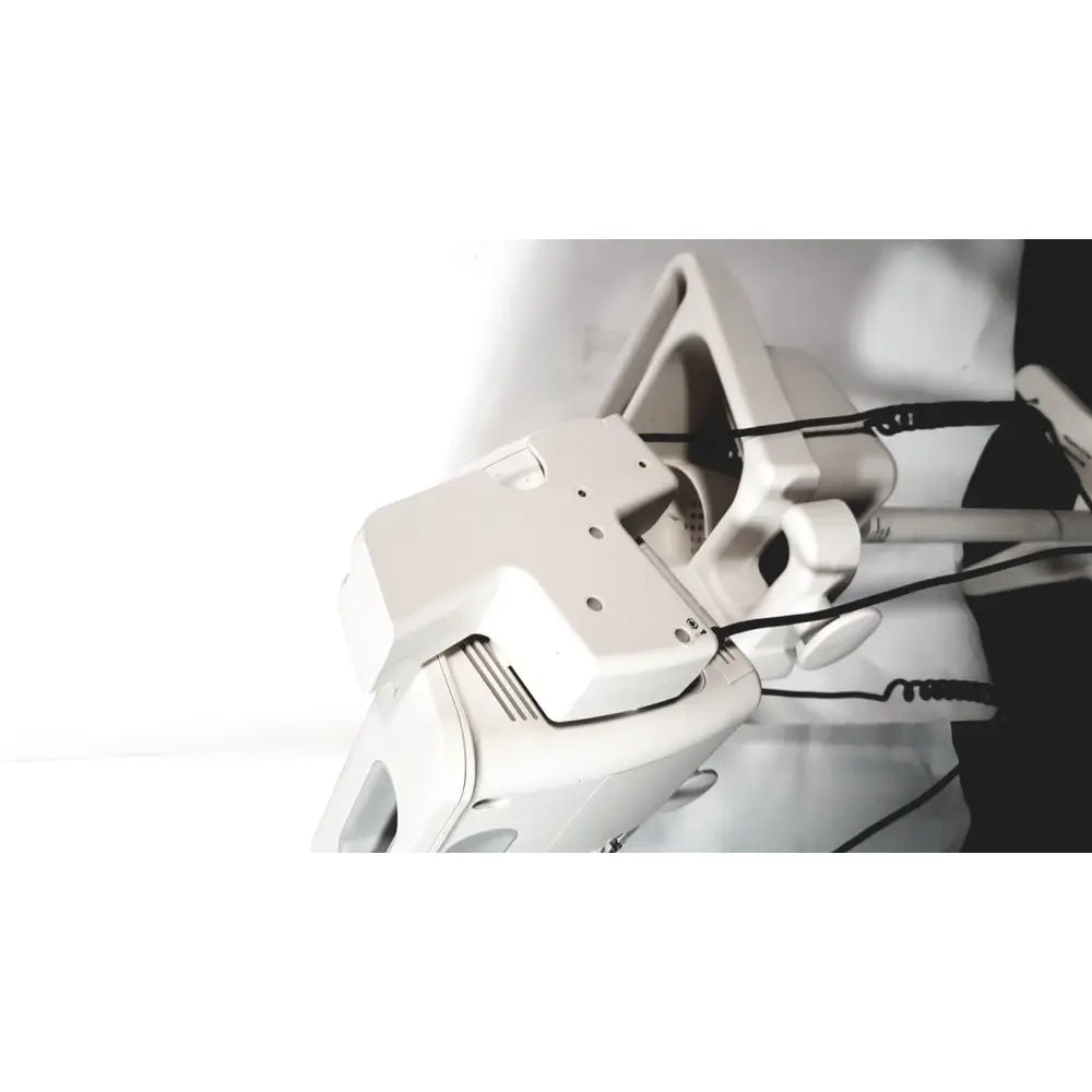 White plastic philips suresigns vs4 patient monitor with articulated joints and coiled black cables visible