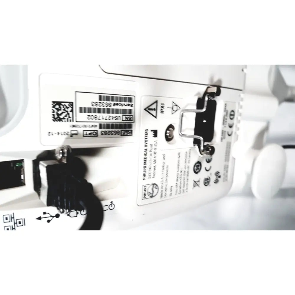 Back view of white philips suresigns vs4 patient monitor with black connectors and label showing model and certification details