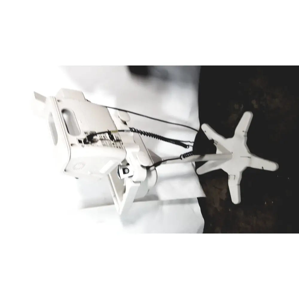 White industrial sewing machine with star-shaped base and coiled cable featured alongside philips suresigns vs4 patient monitor