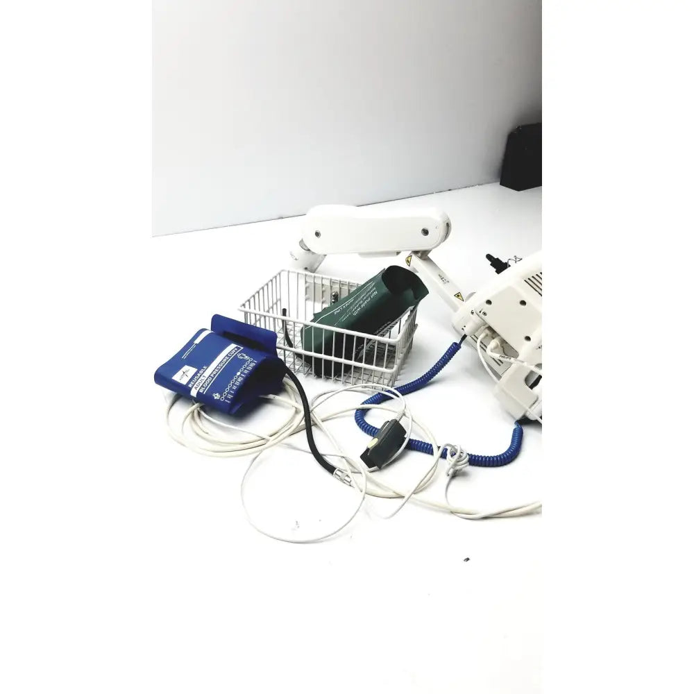White medical robotic arm with coiled blue tubing attached to philips suresigns vs4 vital signs monitor with accessories
