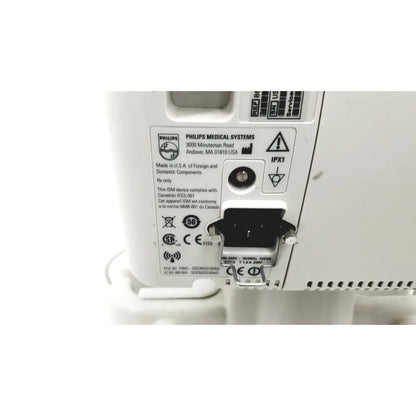 White philips suresigns vs4 vital signs device with black power connector and regulatory labels on back side