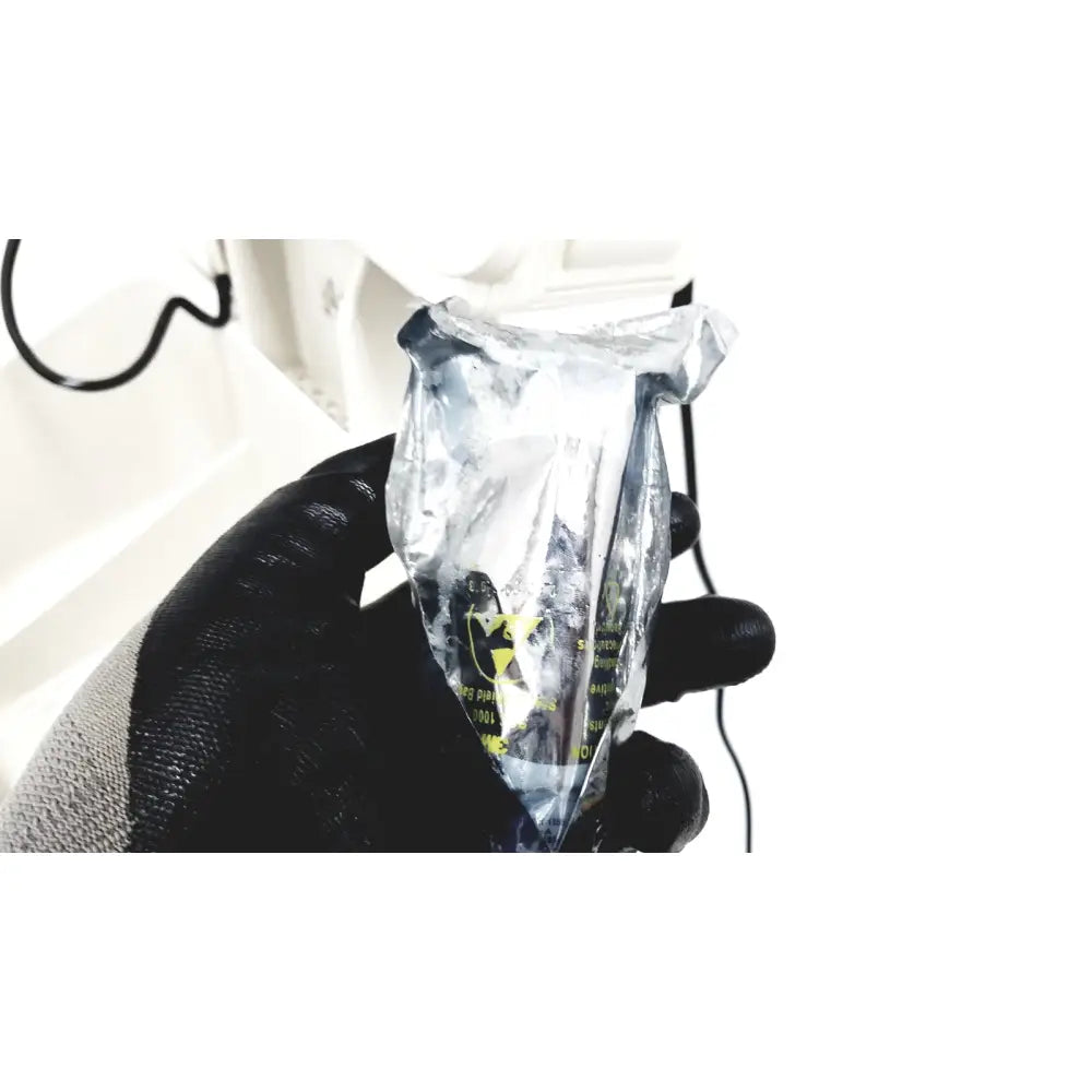 A clear plastic bag containing a small metallic object with yellow warning labels for philips suresigns vs4 vital signs device