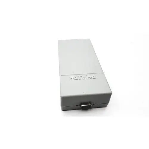 Gray rectangular sony playstation 2 console with matte finish and visible power port shown with philips tectrol upc patient monitor medical power supply