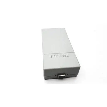 Gray rectangular sony playstation 2 console with matte finish and visible power port shown with philips tectrol upc patient monitor medical power supply