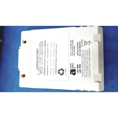 White rectangular physio control lifepak 12v 1.8ah ni-cad battery with gold terminals and safety instructions for cardiac monitor
