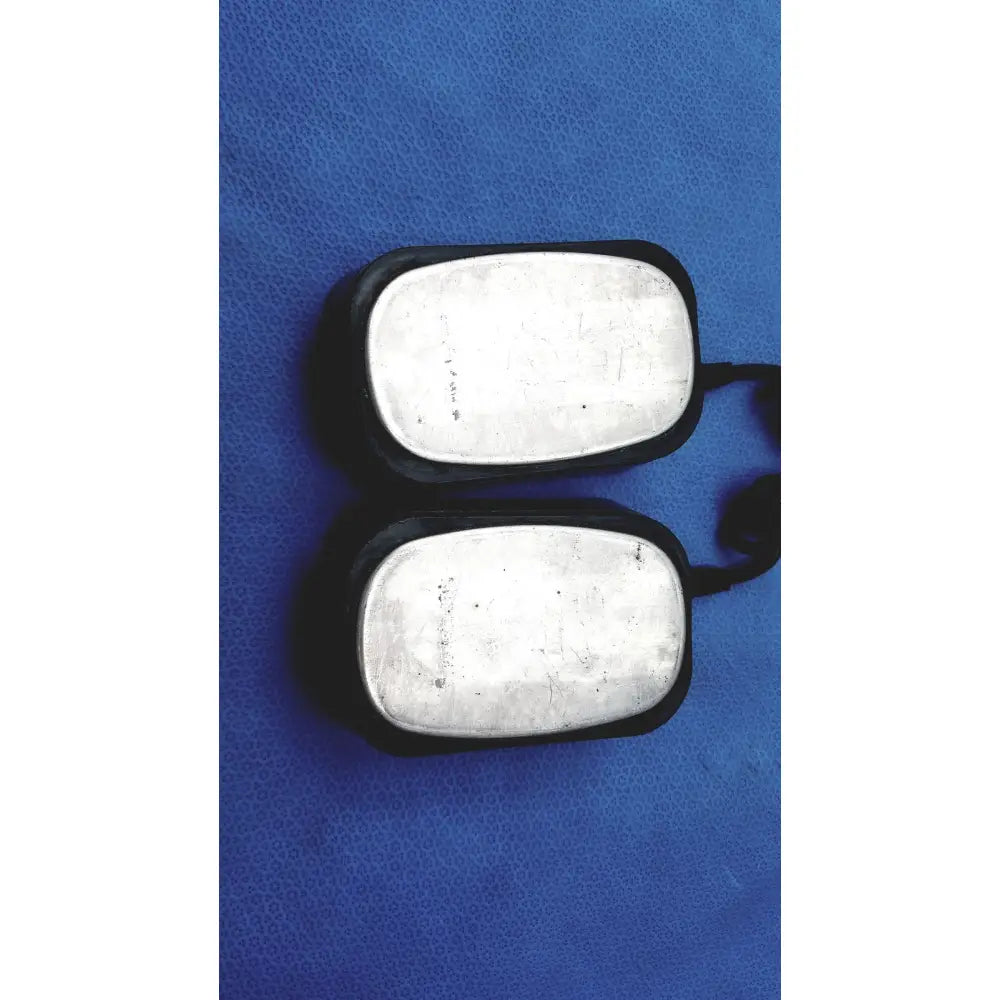 Black dog tags with silver metal plates shown with physio control lifepak 10 cardiac monitor for identification