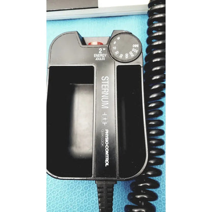 Black plastic sternal defibrillator with circular joules dial and energy setting on physio control lifepak 10 cardiac monitor