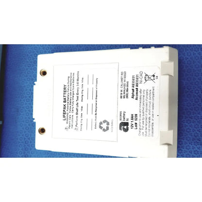 White rectangular physio control lifepak battery with label and two circular mounting holes for cardiac monitor use