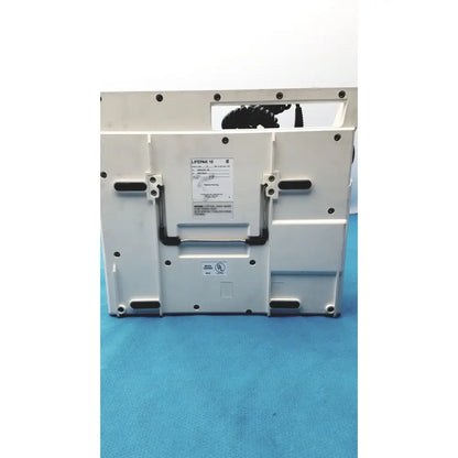 White physio control lifepak 10 cardiac monitor defibrillator with black accents and model label visible