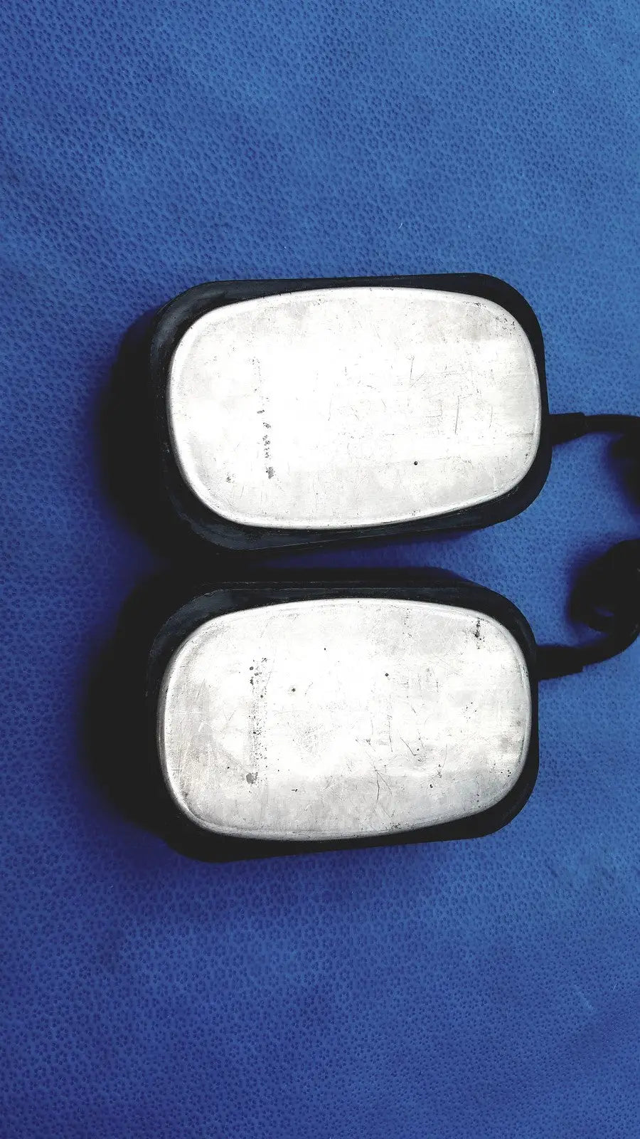 Black dog tags with silver metal plates shown with physio control lifepak 10 cardiac monitor for identification