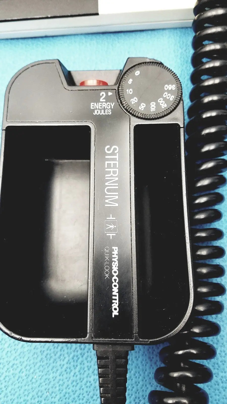Black plastic sternal defibrillator with circular joules dial and energy setting on physio control lifepak 10 cardiac monitor