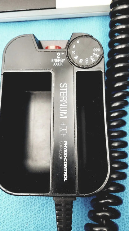 Black plastic sternal defibrillator with circular joules dial and energy setting on physio control lifepak 10 cardiac monitor