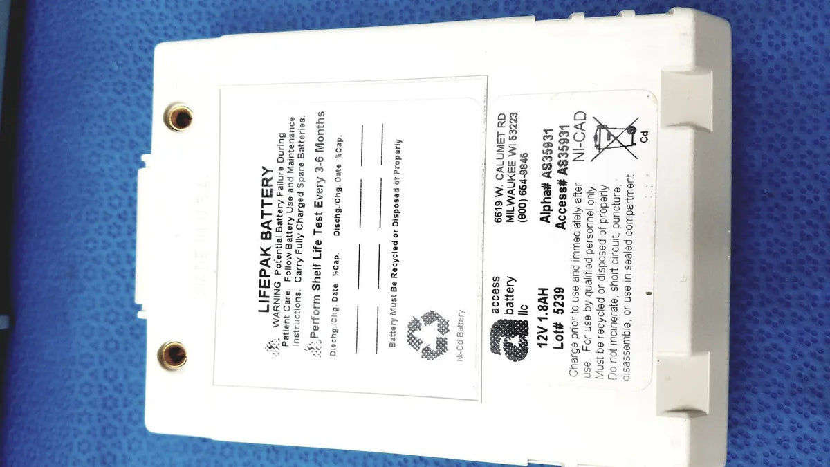 White rectangular physio control lifepak battery with label and two circular mounting holes for cardiac monitor use