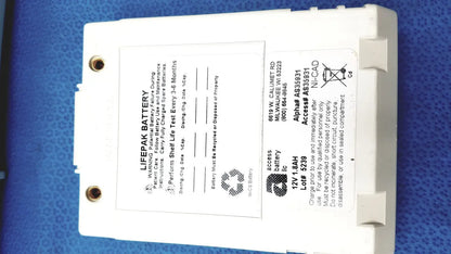 White rectangular physio control lifepak battery with label and two circular mounting holes for cardiac monitor use