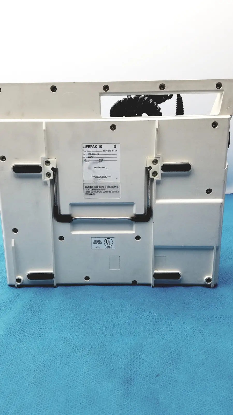 White physio control lifepak 10 cardiac monitor defibrillator with black accents and model label visible