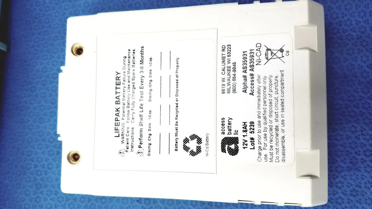 White rectangular physio control lifepak 12v 1.8ah ni-cad battery with gold terminals and safety instructions for cardiac monitor