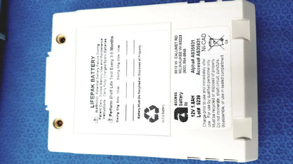 White rectangular physio control lifepak 12v 1.8ah ni-cad battery with gold terminals and safety instructions for cardiac monitor
