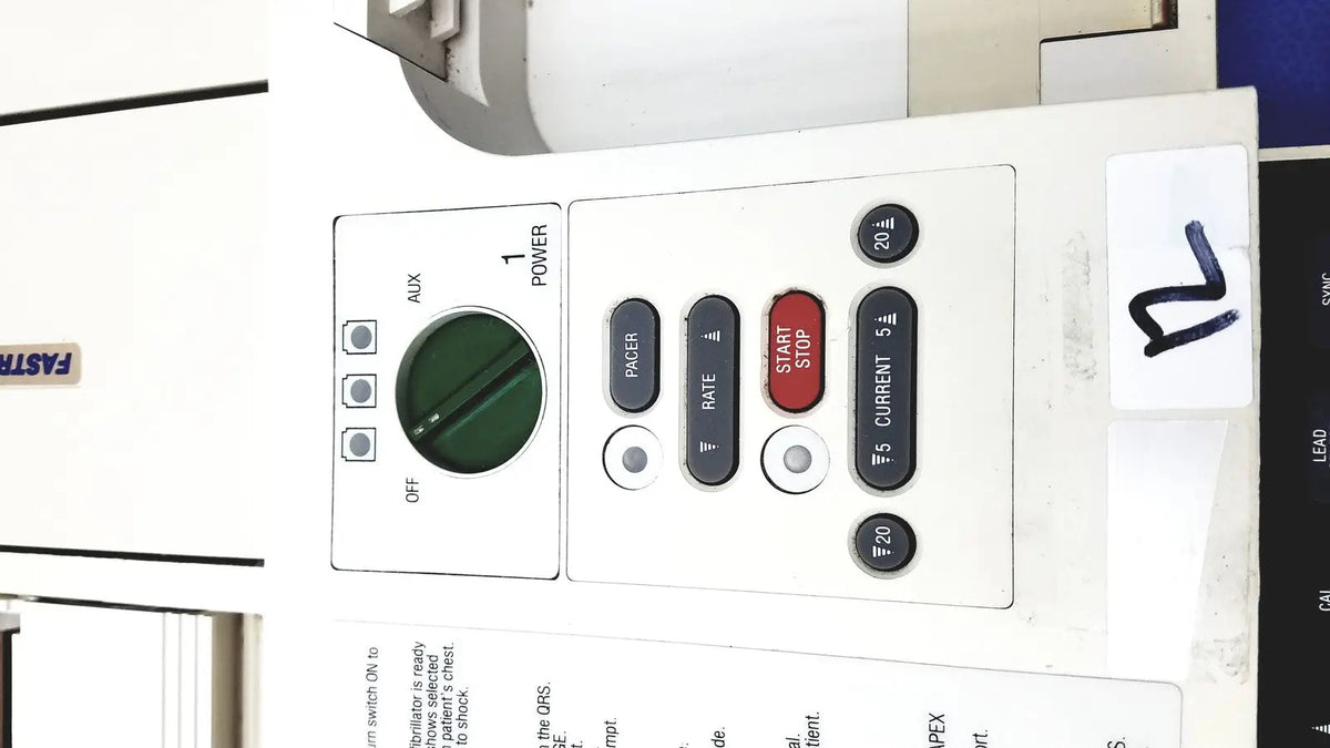 White industrial physio control lifepak 10 cardiac monitor control panel with green dial and black red buttons