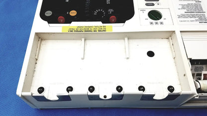 White plastic medical training mannequin with black control panel and warning label for physio control lifepak 10 cardiac monitor