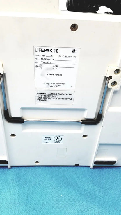 Physio control lifepak 10 cardiac monitor with white case black handle grips and label showing model and safety warnings