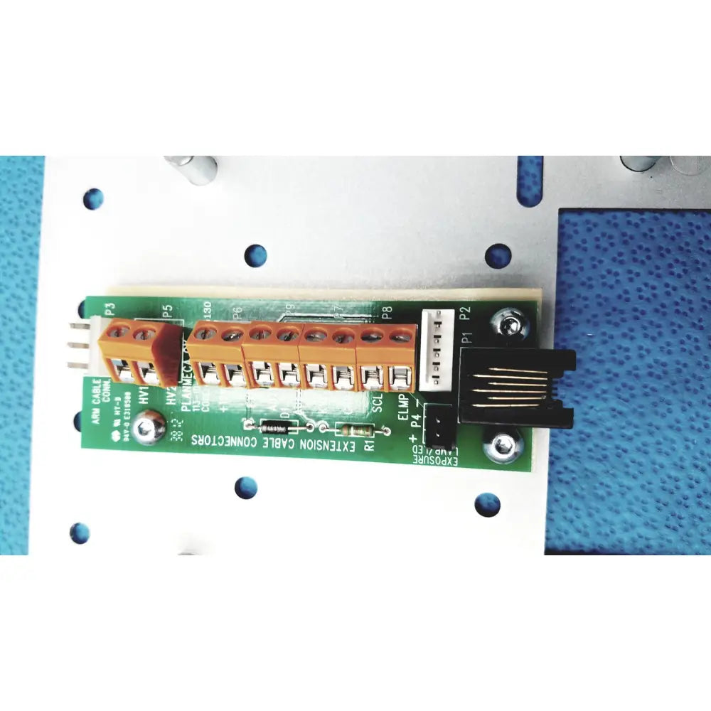 Green circuit board with orange terminal blocks and black ethernet connector on the back of planmeca intra x-ray control pad