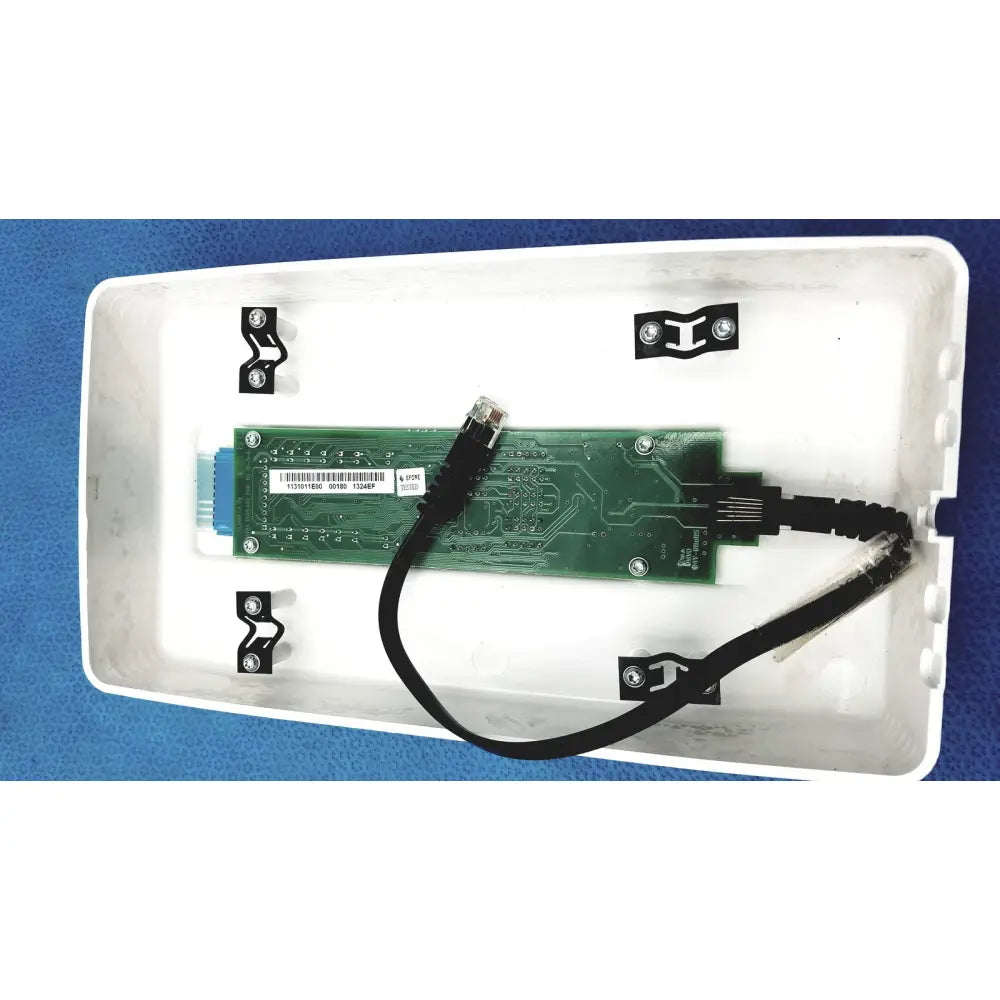 Green circuit board with black cable and silver screws inside white plastic enclosure of planmeca intra x-ray control pad back side