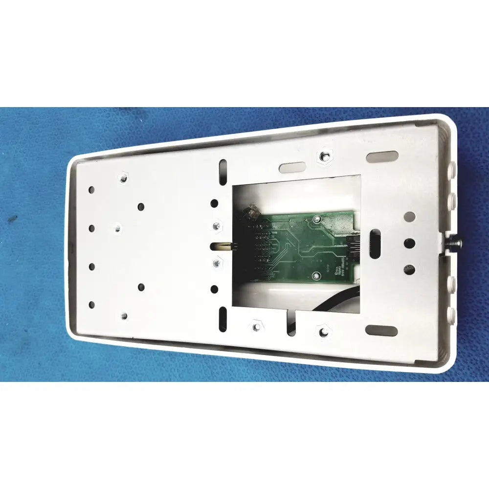White rectangular wall-mounted control pad housing with green circuit board inside for planmeca intra x-ray system