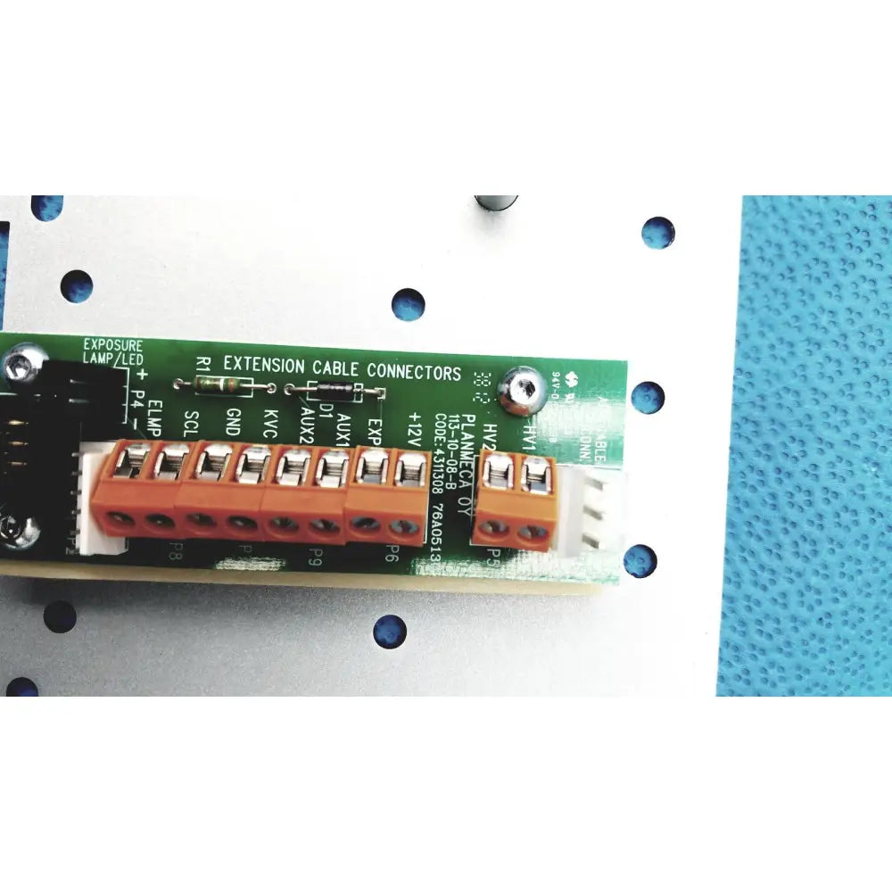 Orange plastic extension cable connectors mounted on a green circuit board of the Planmeca Intra x-ray control pad back side