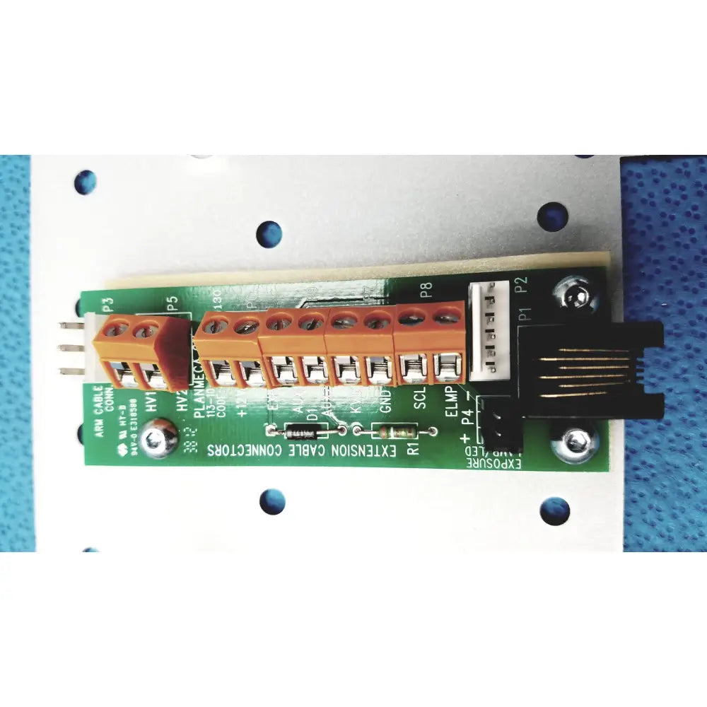 Green circuit board with orange terminal blocks and black connectors on the back side of planmeca intra x-ray control pad