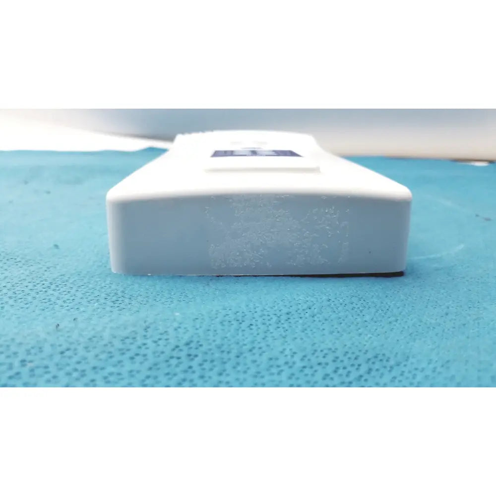 White rectangular plastic control pad bottle with a dark blue label for Planmeca intra x-ray system