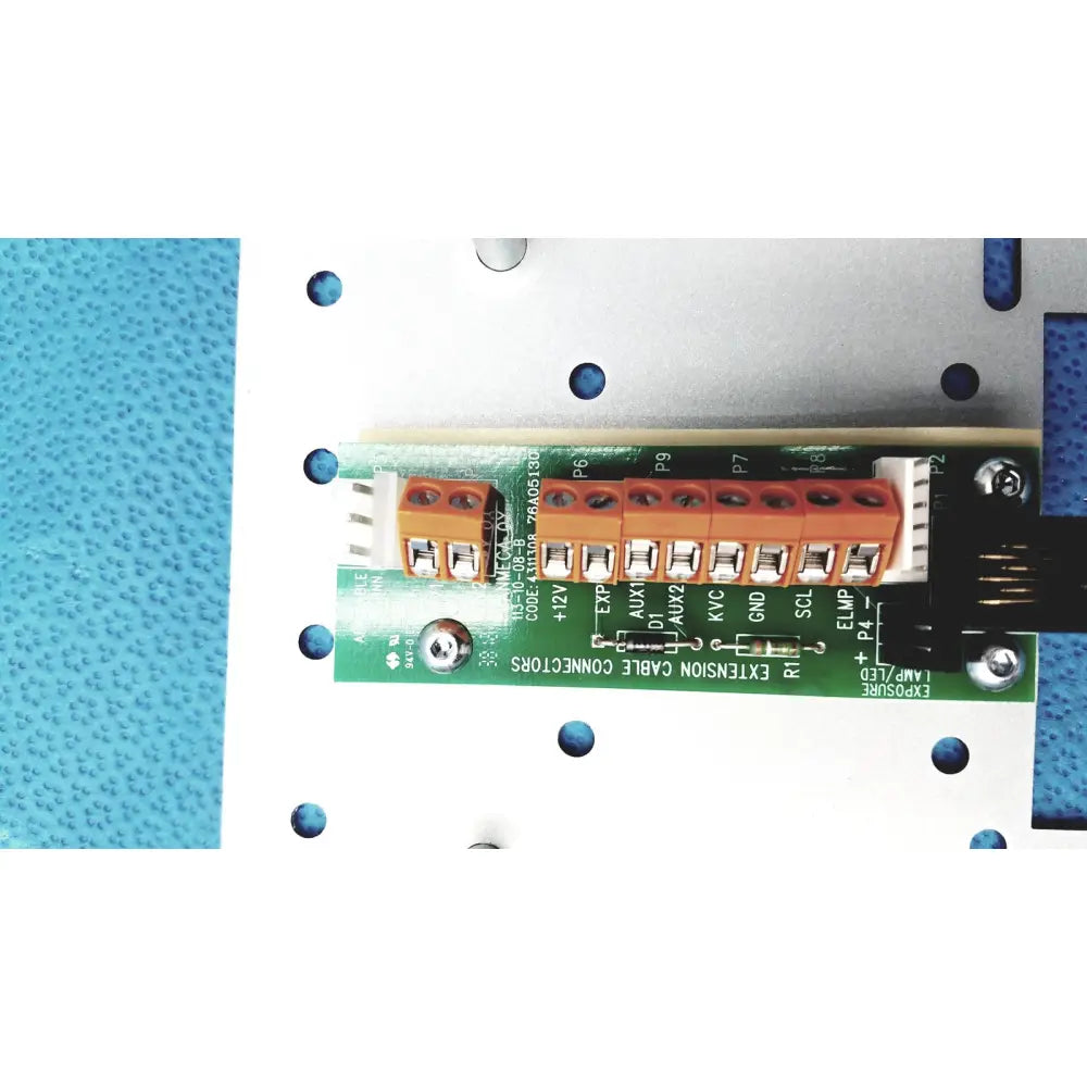 Orange terminal block with labeled connection points on green circuit board of planmeca intra x-ray control pad back side