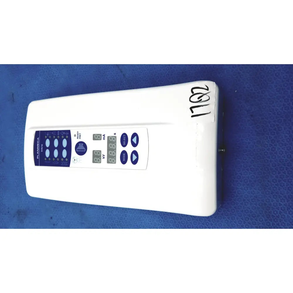 White rectangular Planmeca Intra control pad with blue panel and digital displays for Planmeca Intra x-ray settings