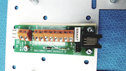 Green circuit board with orange terminal blocks and black ethernet connector on the back of planmeca intra x-ray control pad