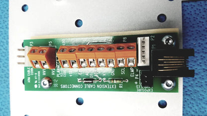 Green circuit board with orange terminal blocks and black connectors on the back side of planmeca intra x-ray control pad