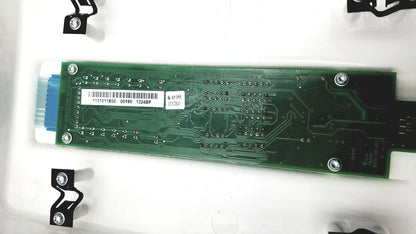 Green rectangular circuit board with silver screws and blue connector of planmeca intra x-ray control pad back side