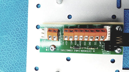 Orange terminal block with labeled connection points on green circuit board of planmeca intra x-ray control pad back side
