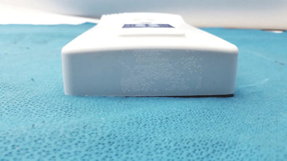 White rectangular plastic control pad bottle with a dark blue label for Planmeca intra x-ray system