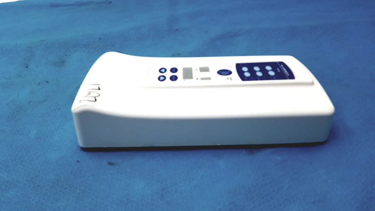 White rectangular Planmeca intra x-ray control pad with blue control panel and buttons for precise device operation