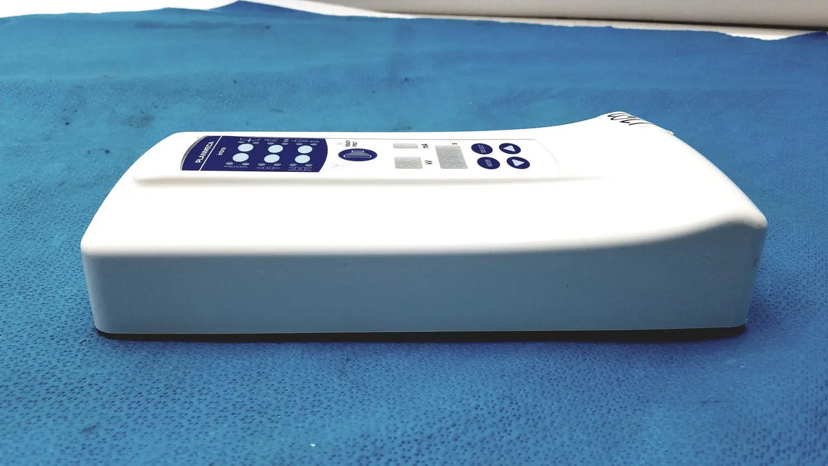 White rectangular planmeca intra x-ray control pad with blue button panel and small display screen for dental imaging