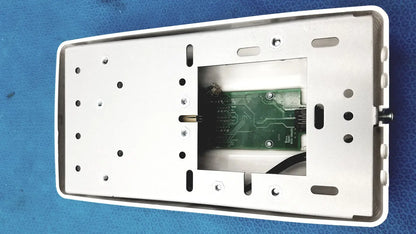 White rectangular wall-mounted control pad housing with green circuit board inside for planmeca intra x-ray system