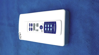 White rectangular planmeca intra x-ray control pad with blue digital display panel branded planmeca on front