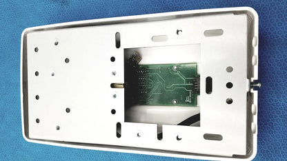 White plastic wall-mounted housing with visible green circuit board for planmeca intra x-ray control pad backside view