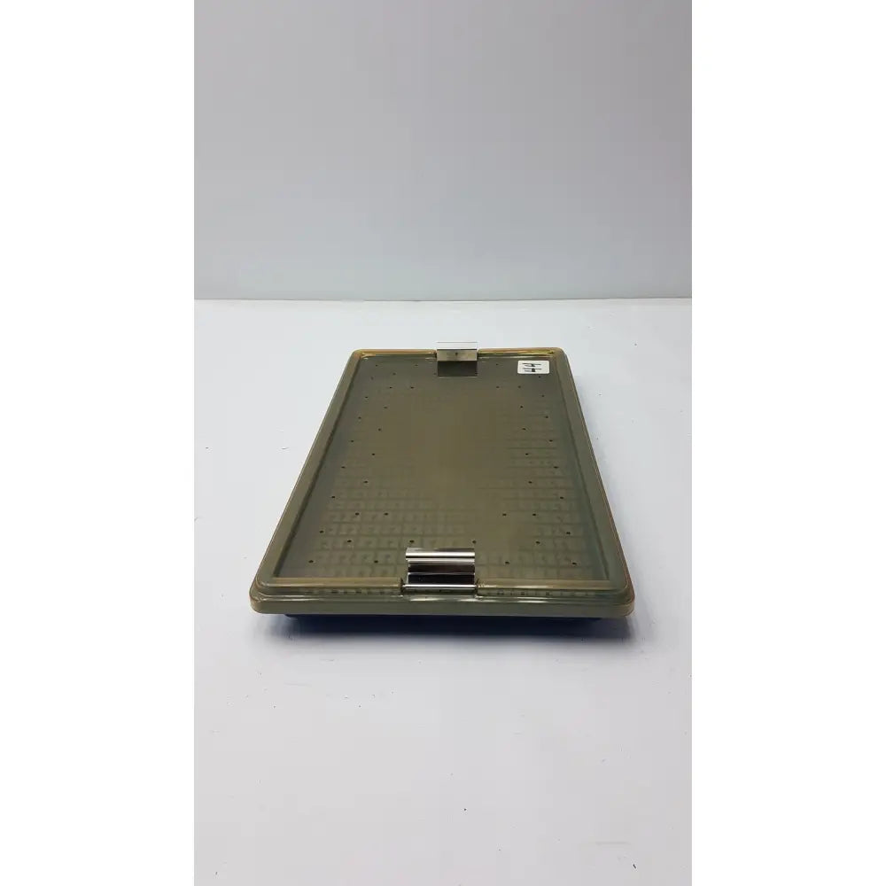 Olive-green plastic sterilization tray with silicone finger mat textured surface and secure metal clasp for surgical use