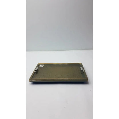 Olive green plastic sterilization tray with two metallic handles and a silicone finger mat for secure instrument storage